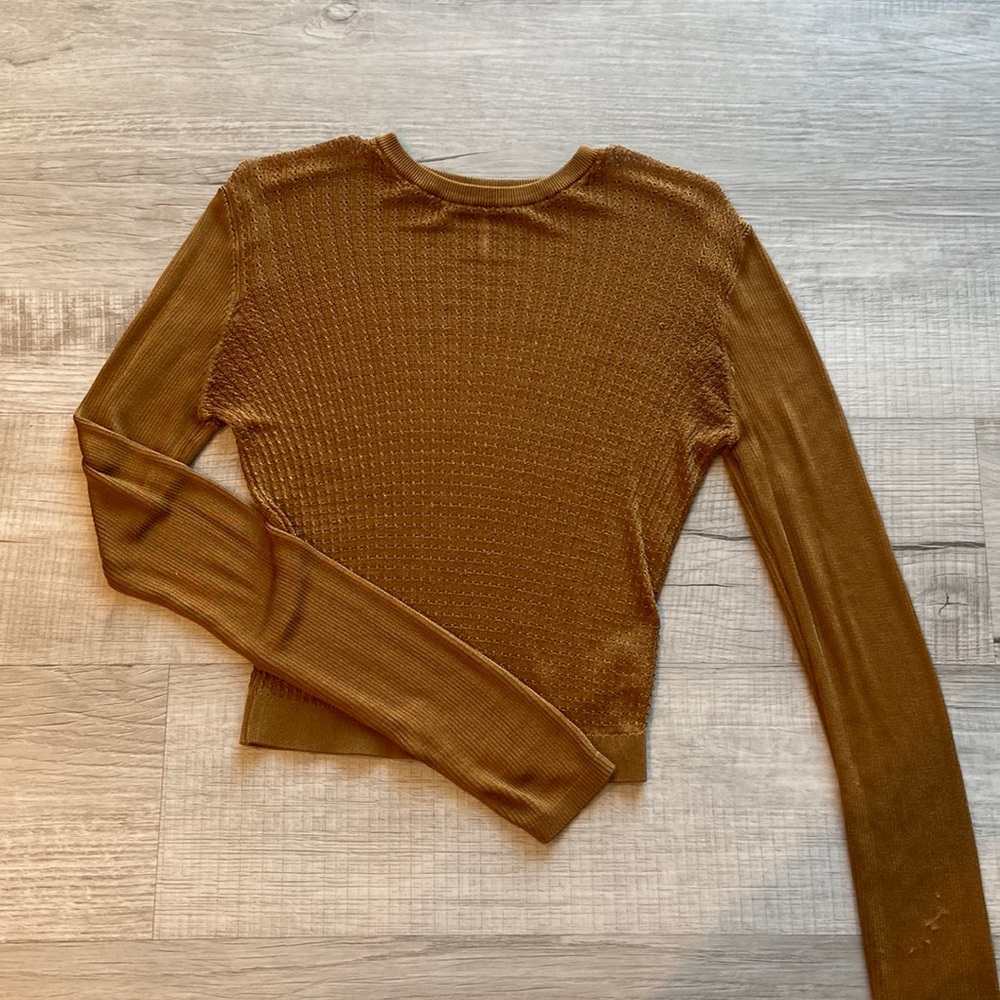 Free people sheer top. Fitted but stretchy. Never worn washed once.